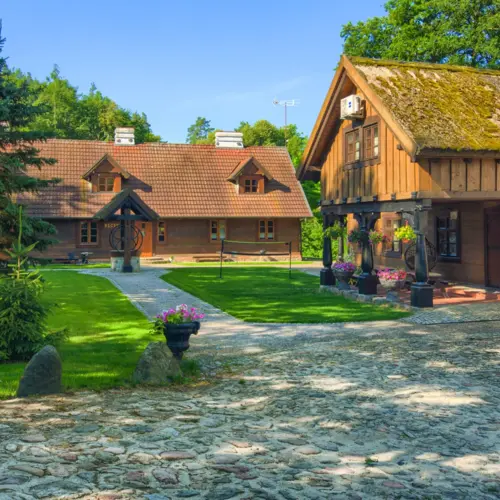Green courtyard and wooden buildings