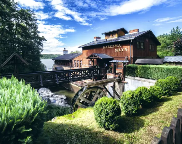 Karczma Młyn with a water wheel
